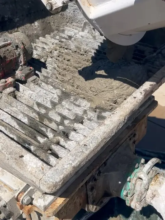 Long 100 ft hose run delivering concrete to a hard-to-reach pour