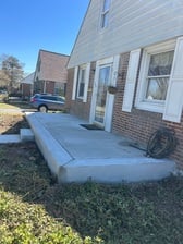 Finished concrete sidewalk and step poured by Dougherty Concrete